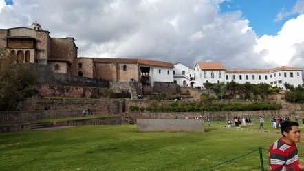 The Qorikancha. The black stones on the left are an original Incan wall with the Dominican church behind it. The white buildings to the right make up the monastery. 